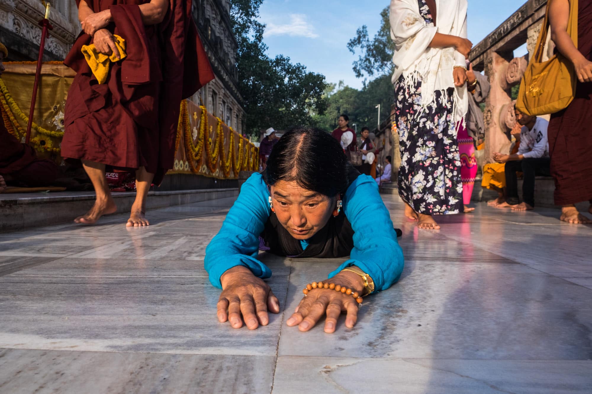 A tibetan lady undertakes a parikrama of the Mahabodhi temple